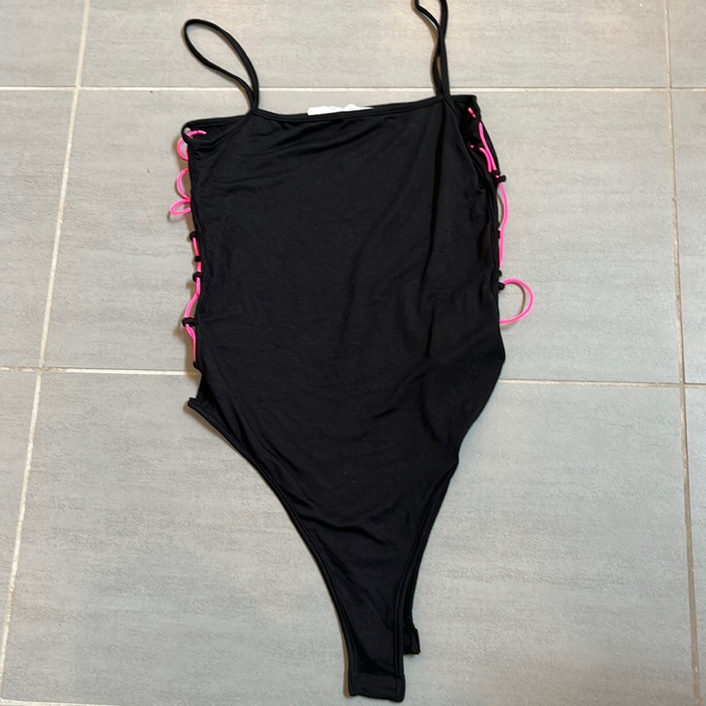 NEVER WORN. Emma and Sam size Large bodysuit. Stretchy neon pink cords each side